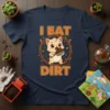 Cute cartoon cat holding a trowel and eating dirt, with text "I EAT DIRT" on a navy t-shirt
