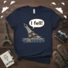 Navy t-shirt with a graphic of the Eiffel Tower leaning over and a speech bubble saying "I fell!"