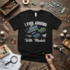 Black t-shirt featuring the text "I FOOL AROUND With Models" and illustrations of various models like a train, tanks, and