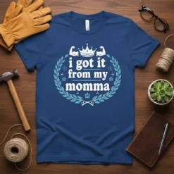 I Got It From My Momma text with a crown and flexed arm graphics on a blue t-shirt