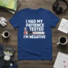 T-shirt with white text "I HAD MY PATIENCE TESTED I'M NEGATIVE" above a thermometer graphic featuring a grumpy black cat
