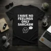 Black t-shirt with white text "I HAVE NO FEELINGS ONLY SARCASM" and a graphic of an angry face with a