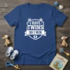 White text "I HAVE TWINS SO I WIN" with crown and baby footprints on a royal blue t-shirt