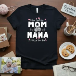 T-shirt with text "I Have Two Titles MOM NANA and I Rock Them Both" in white and pink typography, featuring