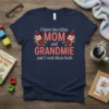 Navy t-shirt with floral accents and the text "I have two titles MOM and GRANDMIE and I rock them both"