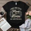 T-shirt with text "I HAVE TWO TITLES Mom AND Nana AND I ROCK THEM BOTH" in a floral wreath design