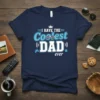 Navy t-shirt with "I Have The Coolest Dad Ever" text in blue and white, featuring sunglasses and gaming icons