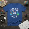 I Have to Say Weird Stuff Or I'll Die quote on a blue t-shirt with quirky monsters and a brain