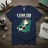 Funny cat wearing glasses reading a book with text "I HEAR YOU I'M JUST NOT LISTENING" on a navy t-shirt