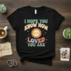Retro t-shirt design with text "I Hope You Know How Loved You Are" and a smiling sun graphic