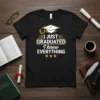Black t-shirt with yellow and white text "I JUST GRADUATED I know EVERYTHING" and graduation cap graphic