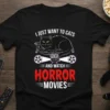 I Just Want to Cats and Watch Horror Movies T-Shirt featuring a black cat and film projector graphic