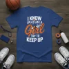 Blue t-shirt with white and orange text "I Know I Play Like A Girl Try To Keep Up" and a