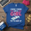 I Know I Throw Like A Girl Try To Keep Up text with cornhole graphic on a blue t-shirt