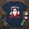 Funny Christmas t-shirt design with Santa Claus holding a toothbrush and dental floss, text reads "I Know You Didn't Floss"