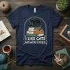 I Like Cats And Maybe 3 People text with black cat on books graphic on navy t-shirt