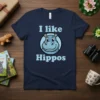 I like Hippos t-shirt with a cartoon illustration of a friendly blue hippo face in a circle