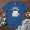 I Like To Stay Home With My Cat t-shirt design featuring a sleeping cat on an armchair