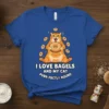 I LOVE BAGELS AND MY CAT PURR-FECTLY ROUND text with an orange cat holding a bagel graphic on a blue
