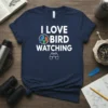 Navy blue t-shirt with white text "I LOVE BIRD WATCHING" and graphic of three colorful birds and binoculars