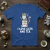 T-shirt design featuring the text "I LOVE CATS AND TEA" above a cute cat sitting in stacked teacups