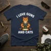 T-shirt with "I Love Guns And Cats" text, featuring an orange tabby cat holding crossed rifles