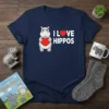 I Love Hippos T-Shirt with cute hippopotamus holding a red heart and white text
