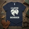 I Love Horses text with a white horse head inside a heart graphic on a navy t-shirt