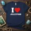Navy blue t-shirt with white text "I LOVE JELLYFISH" and a red heart graphic, celebrating marine life