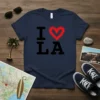 I Love LA t-shirt design with bold black text and a red heart symbol for 'love'
