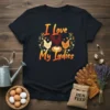 I Love My Ladies t-shirt design with a rooster, hens, and eggs in a nest, surrounded by floral accents