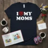 I Love My Moms text with a red heart symbol on a navy t-shirt, perfect for Mother's Day