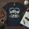 I Love My RV Life t-shirt with a heart-shaped graphic featuring a camper, trees, and a campfire, plus heartbeat line