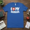 Blue t-shirt with white text "I LOVE MY SCHOOL" and a red book inside a shield graphic