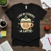 I Love My Students A Latte quote on a black t-shirt with a coffee cup, open book, and hearts design
