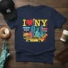 I Love New York City graphic tee featuring Statue of Liberty, yellow taxi, burger, pizza, and Broadway and Wall Street