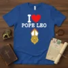 I Love Pope Leo T-Shirt featuring bold white text and a red heart graphic above a lion wearing a papal