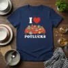 Navy blue t-shirt with "I Love Potlucks" text and an illustration of a potluck table filled with various dishes
