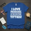 Blue t-shirt with white text: "I LOVE PRONOUNS: LET ME SHE/THEM TITTIES!", featuring bold lettering and a supportive message