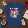 I Love Pups T-Shirt featuring a cute puppy wearing heart-shaped glasses surrounded by pink hearts