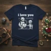 Two cartoon robots holding a broken heart with the text "i love you" above them on a navy t-shirt