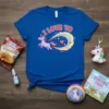 Blue t-shirt with pink text "I LOVE TO" and a purple unicorn with a rainbow trail graphic