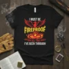 T-shirt with the text "I MUST BE FIREPROOF AFTER ALL THE HELL I'VE BEEN THROUGH" and a phoenix graphic