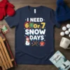 I Need 6 or 7 Snow Days T-Shirt with snowman, hot cocoa, and bike graphics