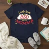 Navy t-shirt with yellow text "I only love my" above a red "BED" inside a cloud, followed by red "MOMM"