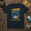 T-shirt with yellow text "I Paused My Game To Be Here" and a cartoon boy at a computer, dark navy
