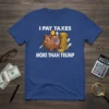 T-shirt with "I Pay Taxes More Than Trump" text, featuring a piggy bank with US flag and stacks of coins