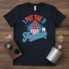 I Put The D In Freedom patriotic t-shirt with American shield graphic and red, white, and blue text