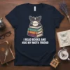 I Read Books And Hug My Moth Friend t-shirt with a cute moth character sitting on a stack of books