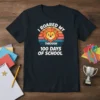 Lion graphic with text "I Roared My Through 100 Days Of School" on a black t-shirt, celebrating 100 days of